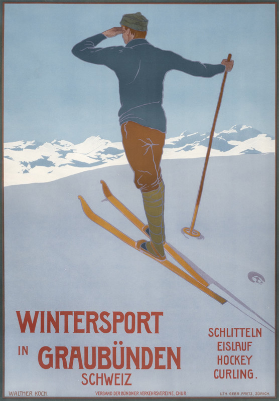 Skier at top of hill looking over mountain; blue, yellow, green