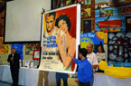 Paul Newman poster on display at charity auction; red, blue, yellow