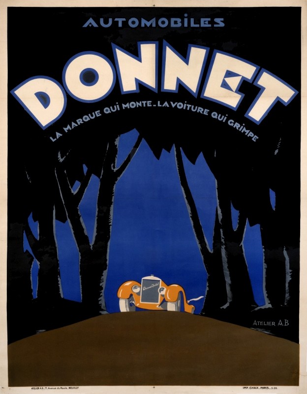 Car rounds bend in wooded area; blue, black, orange, brown