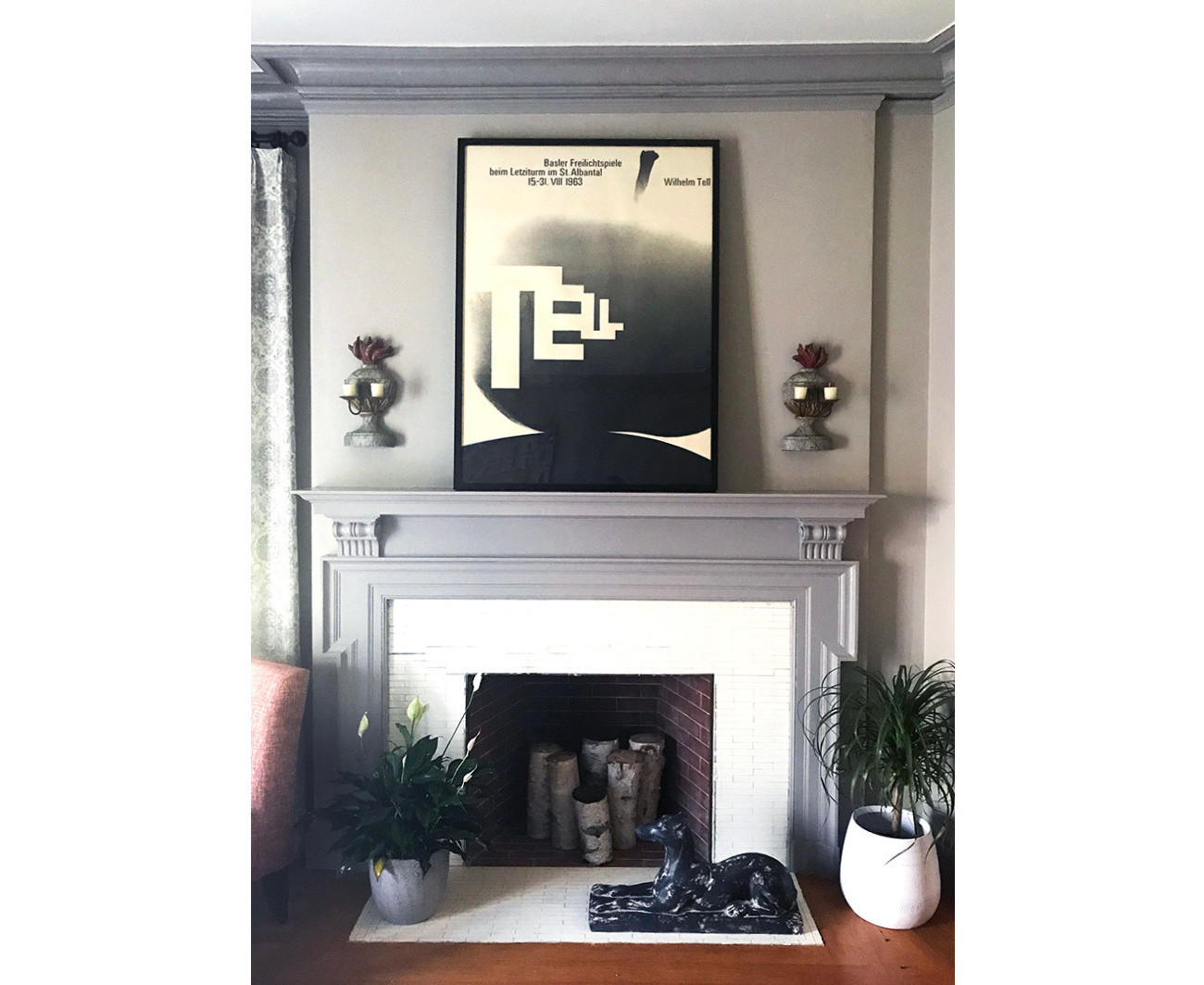 modern home fireplace with typographic poster above; black, white, gray