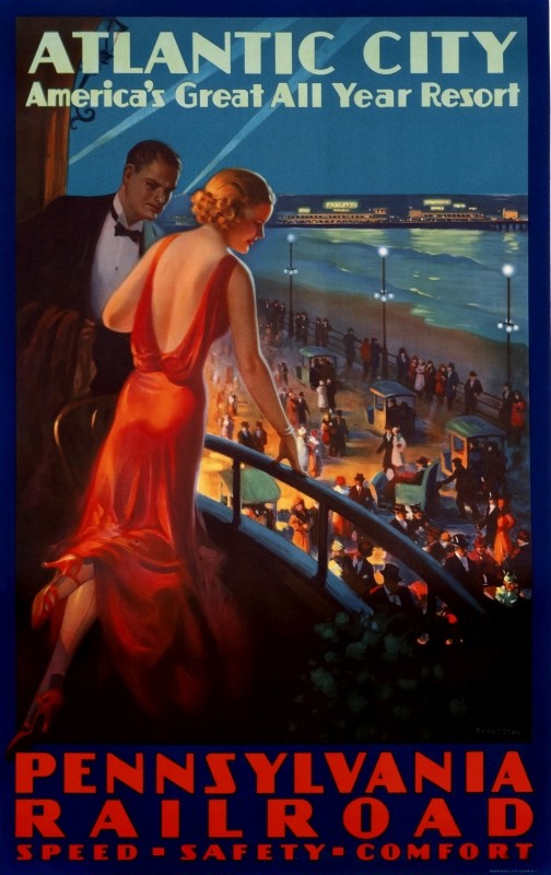 couple on balcony overlook the Boardwalk and beach at night; blue, red, green, beige