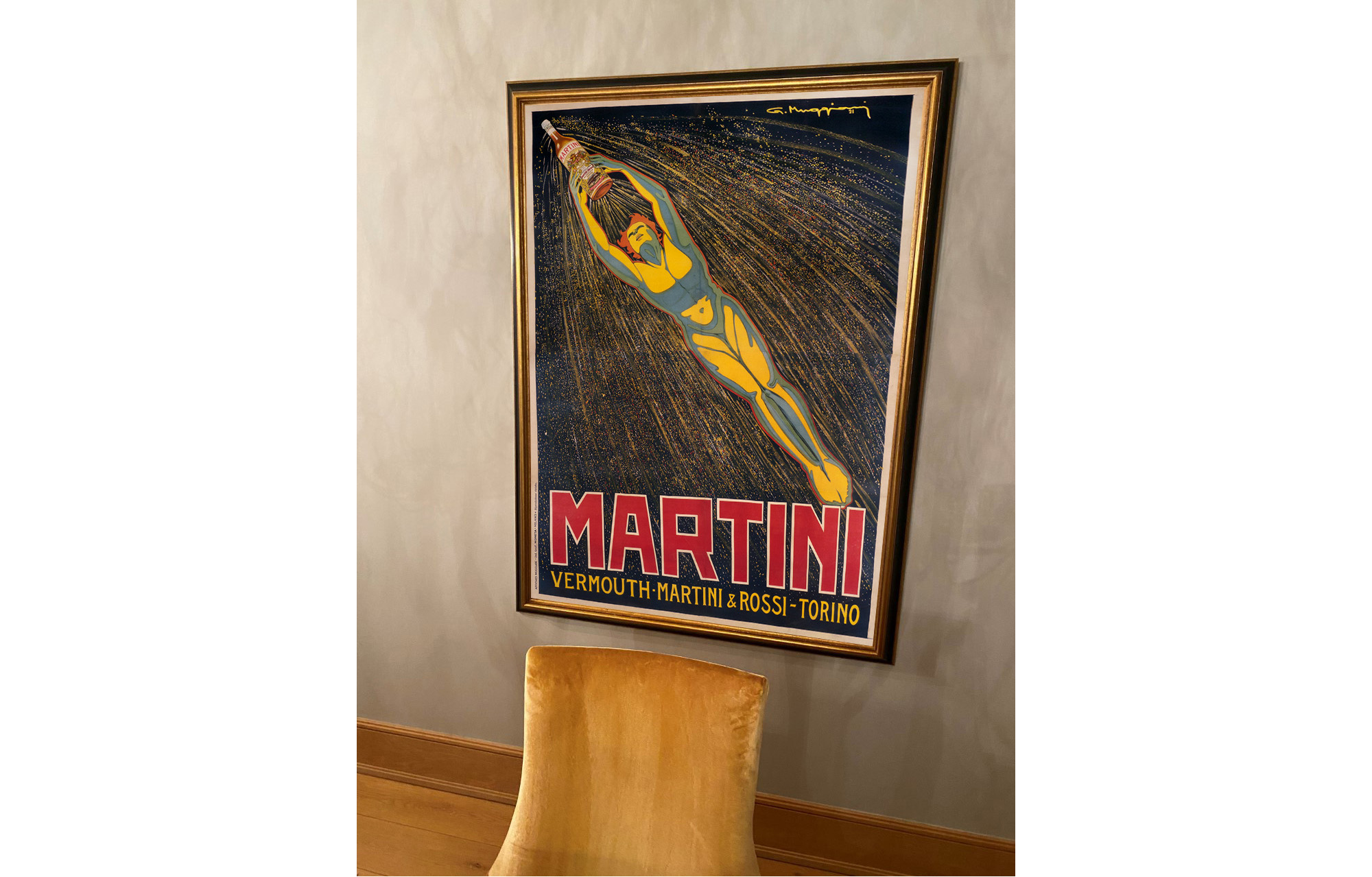 suede chair in front of large poster